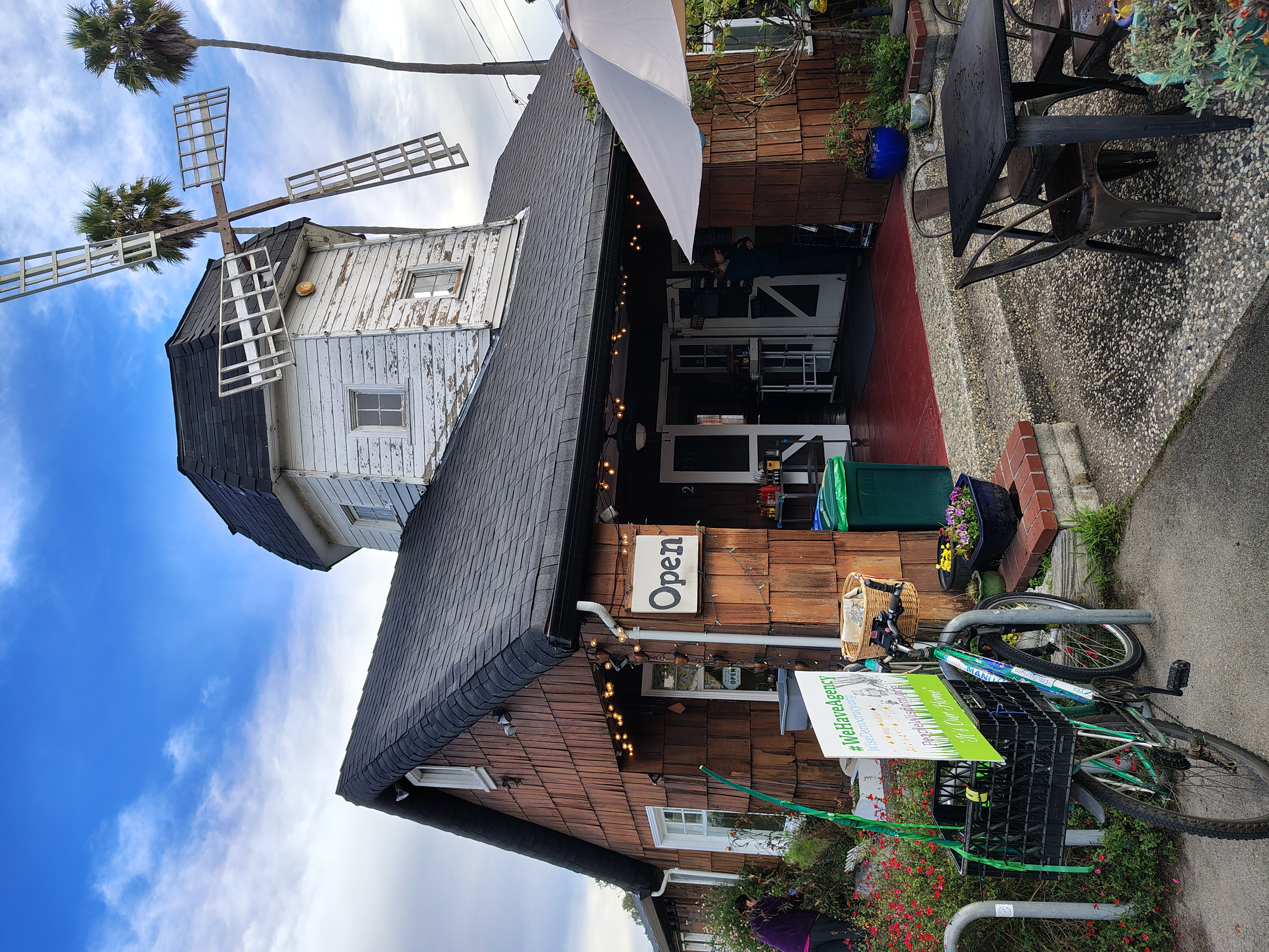 The Windmill Cafe in Santa Cruz, a timber building with a windmill on its roof and outdoor seating