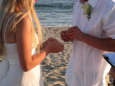 A couple exchanging rings on the sand