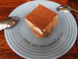 A tiramisu on a plate inscribed with What are you grateful for?